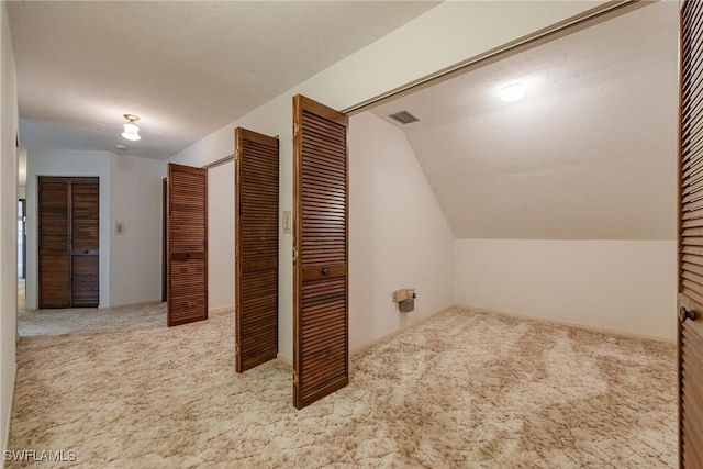 bonus room featuring vaulted ceiling and carpet floors