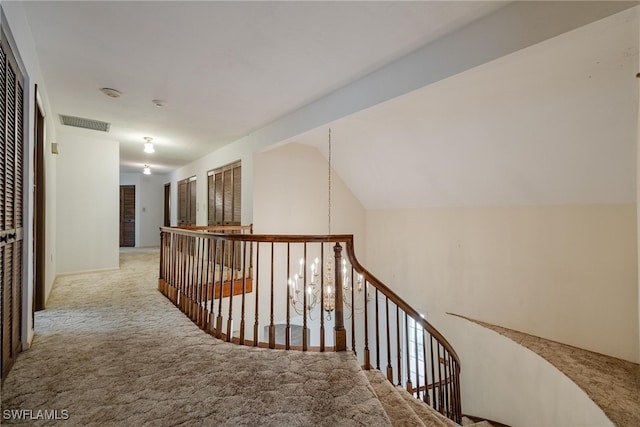 corridor featuring vaulted ceiling and carpet floors