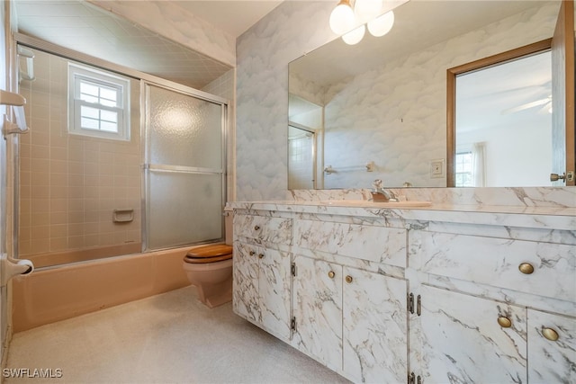 full bathroom with shower / bath combination with glass door, vanity, and toilet