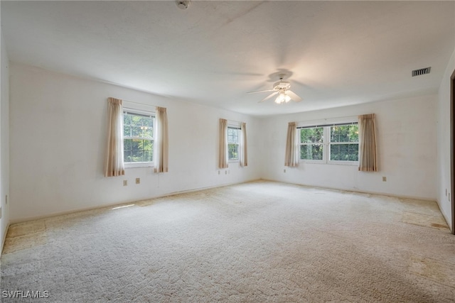 carpeted spare room with ceiling fan