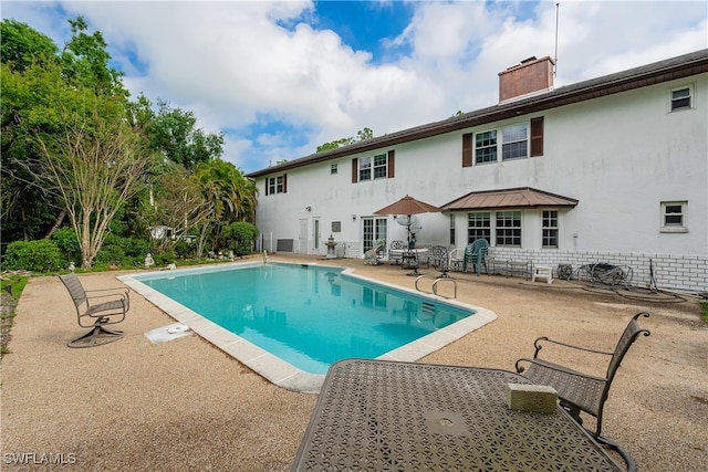 view of swimming pool with a patio area