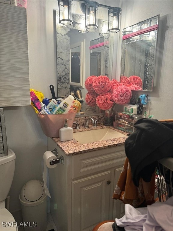 bathroom featuring vanity and toilet