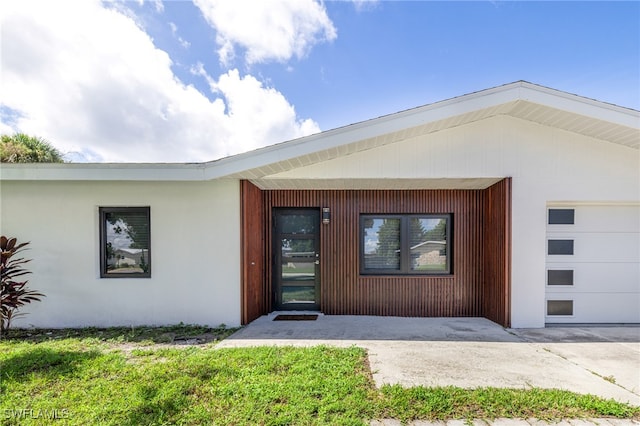 view of exterior entry featuring a garage