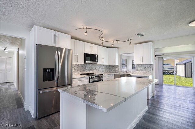 1703 Marina Ter, North Fort Myers, FL 33903 - kitchen with a kitchen island, stainless steel appliances, visible vents, and dark wood-style floors