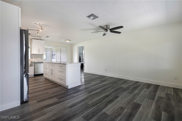 kitchen with backsplash, stainless steel appliances, ceiling fan, white cabinets, and a center island