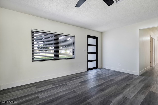 spare room with dark wood-style floors, a textured ceiling, baseboards, and a ceiling fan