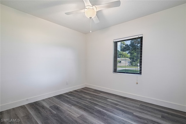 empty room with a textured ceiling, ceiling fan, and dark wood-type flooring