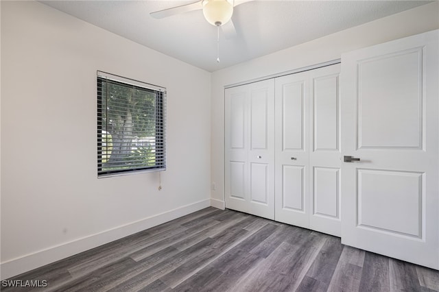 unfurnished bedroom featuring a closet, a ceiling fan, baseboards, and wood finished floors