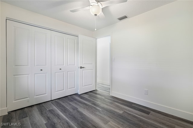 1703 Marina Ter, North Fort Myers, FL 33903 - unfurnished bedroom with dark wood-style flooring, baseboards, visible vents, and a closet