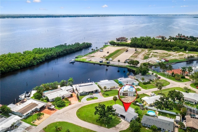 birds eye view of property with a water view and a residential view