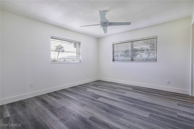 empty room featuring dark wood finished floors, a textured ceiling, baseboards, and ceiling fan