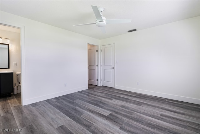 unfurnished bedroom featuring dark wood finished floors, visible vents, a ceiling fan, and baseboards