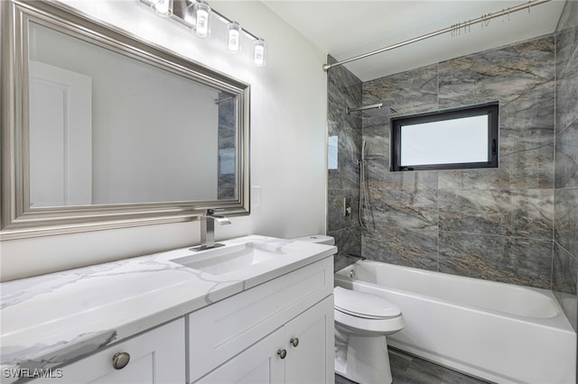 full bathroom featuring hardwood / wood-style flooring, tiled shower / bath combo, toilet, and vanity