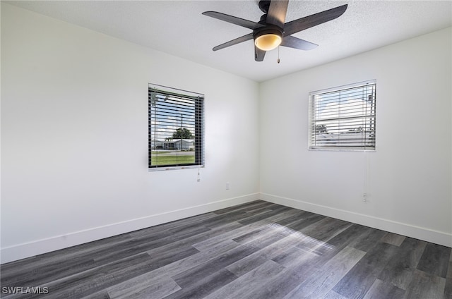 unfurnished room featuring ceiling fan, dark wood-type flooring, and a textured ceiling