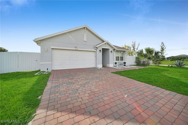 single story home with a garage and a front yard