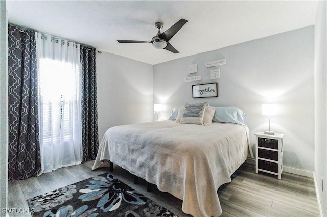 bedroom featuring hardwood / wood-style flooring and ceiling fan