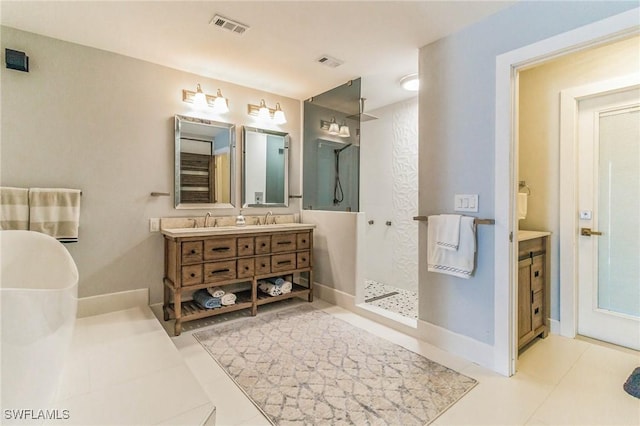 bathroom with visible vents, double vanity, a freestanding bath, a sink, and walk in shower