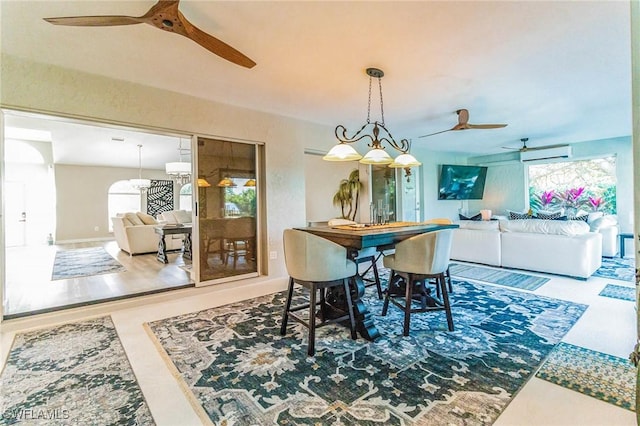 dining area featuring ceiling fan and a wall mounted air conditioner