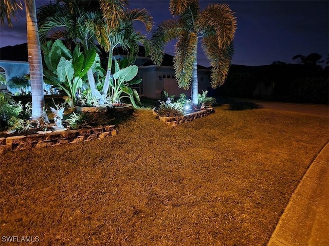 view of yard at twilight