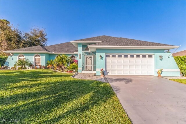 ranch-style house featuring a garage and a front lawn