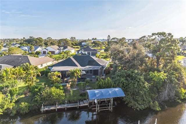 drone / aerial view with a residential view and a water view