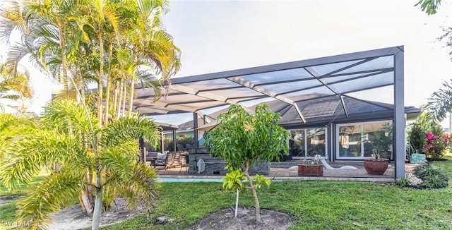 back of house with a lanai, a lawn, an outdoor pool, and a patio