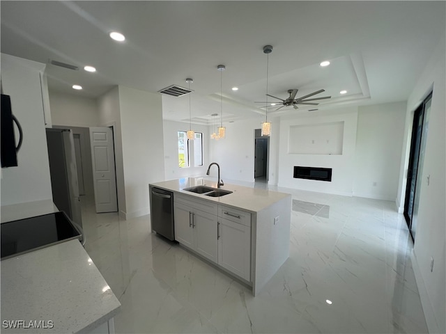 kitchen with white cabinets, sink, black appliances, ceiling fan, and a kitchen island with sink