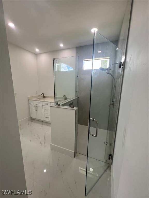 bathroom featuring walk in shower and vanity