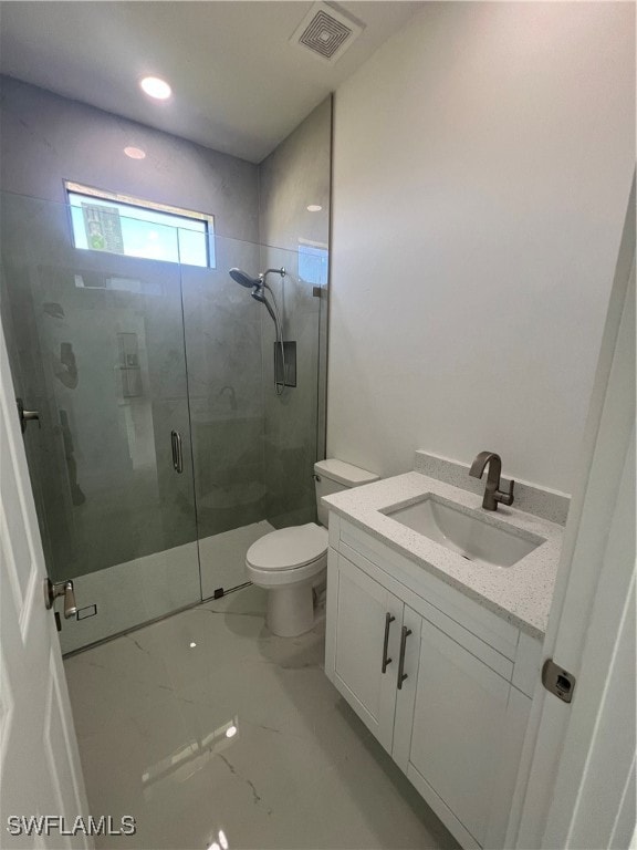 bathroom with vanity, toilet, and an enclosed shower