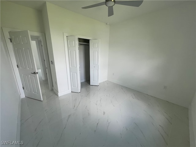 unfurnished bedroom with ceiling fan and a closet