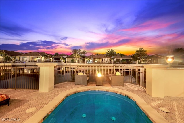 pool at dusk with a deck