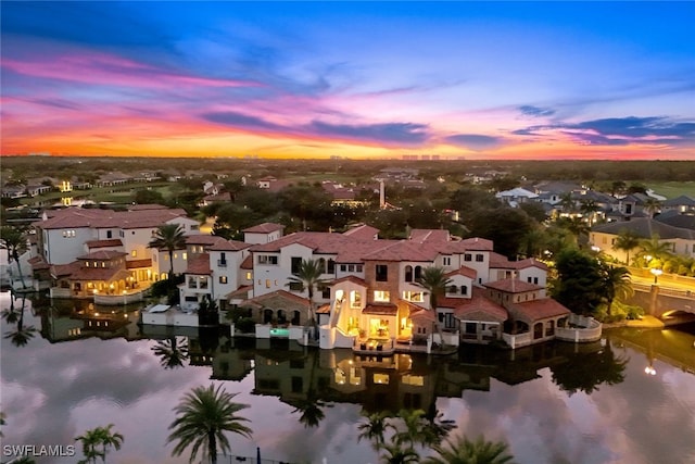 aerial view at dusk with a water view