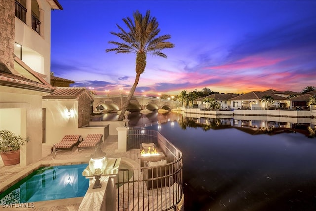 exterior space with a water view and a patio area