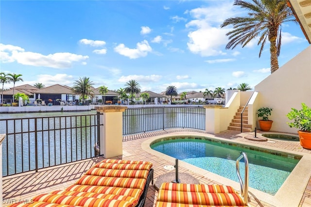 16649 Toscana Cir Unit 803, Naples, FL 34110 - view of swimming pool featuring a hot tub, a water view, a fenced in pool, and a residential view