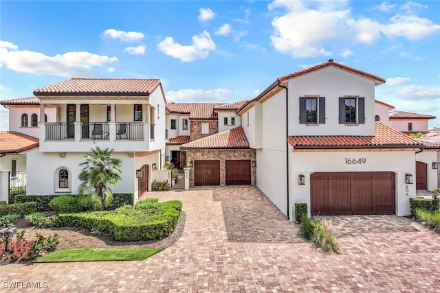 16649 Toscana Cir Unit 803, Naples, FL 34110 - mediterranean / spanish-style home featuring stucco siding, an attached garage, a tiled roof, a balcony, and decorative driveway