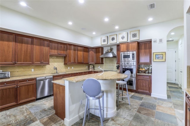 16649 Toscana Cir Unit 803, Naples, FL 34110 - kitchen with a sink, appliances with stainless steel finishes, stone finish floor, visible vents, and arched walkways