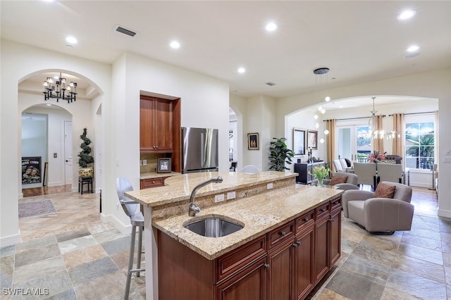 16649 Toscana Cir Unit 803, Naples, FL 34110 - kitchen with a sink, a chandelier, recessed lighting, and freestanding refrigerator