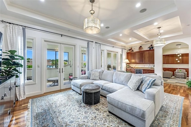 16649 Toscana Cir Unit 803, Naples, FL 34110 - living room with beverage cooler, ornamental molding, french doors, arched walkways, and wood finished floors