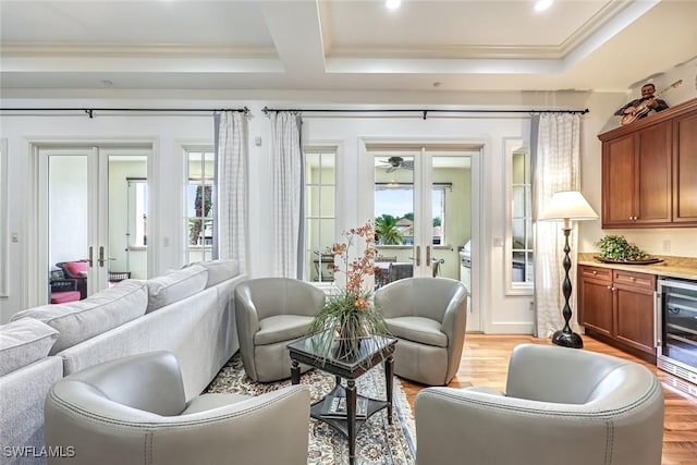 16649 Toscana Cir Unit 803, Naples, FL 34110 - living area with french doors, beverage cooler, ornamental molding, a raised ceiling, and light wood-style floors