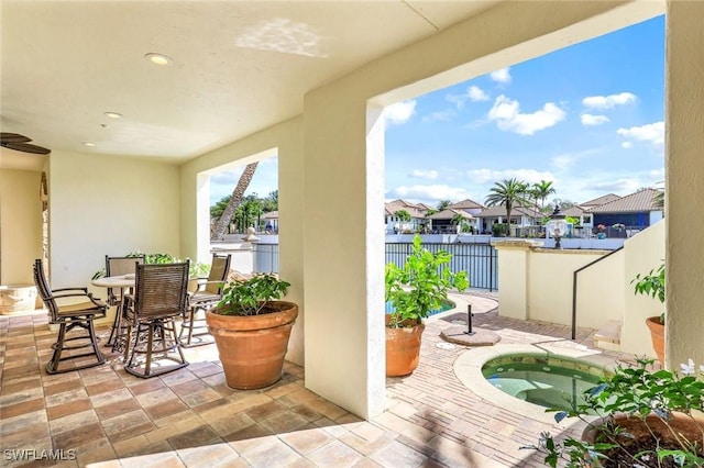 16649 Toscana Cir Unit 803, Naples, FL 34110 - view of patio / terrace featuring an in-ground hot tub and a residential view