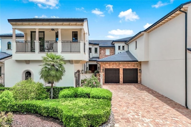 16649 Toscana Cir Unit 803, Naples, FL 34110 - view of front facade with a balcony, stucco siding, an attached garage, and decorative driveway