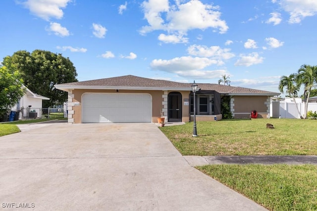 ranch-style house with a garage, central AC, and a front lawn