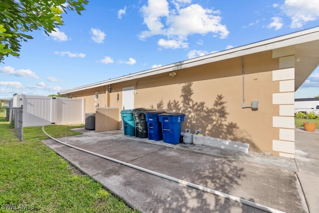 exterior space with central AC unit and a patio