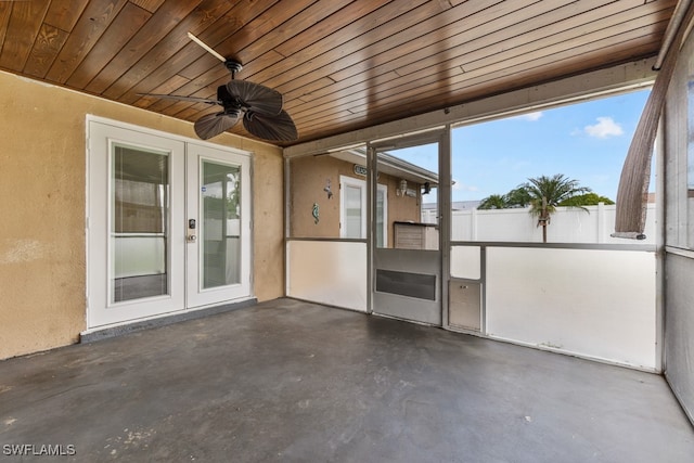 unfurnished sunroom featuring plenty of natural light, wood ceiling, and french doors