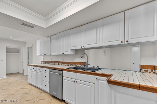 kitchen with white cabinetry, sink, tile countertops, and stainless steel dishwasher