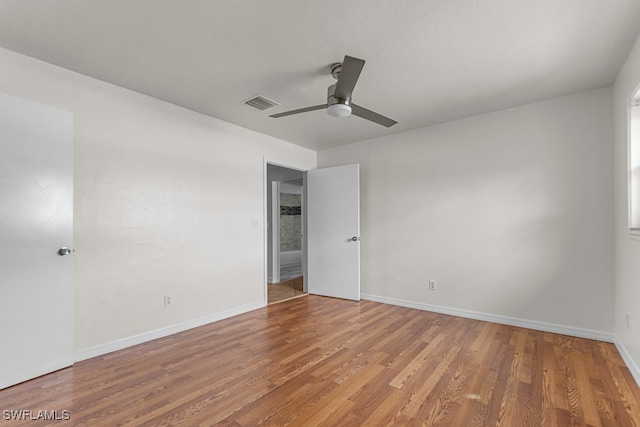 empty room featuring hardwood / wood-style floors and ceiling fan