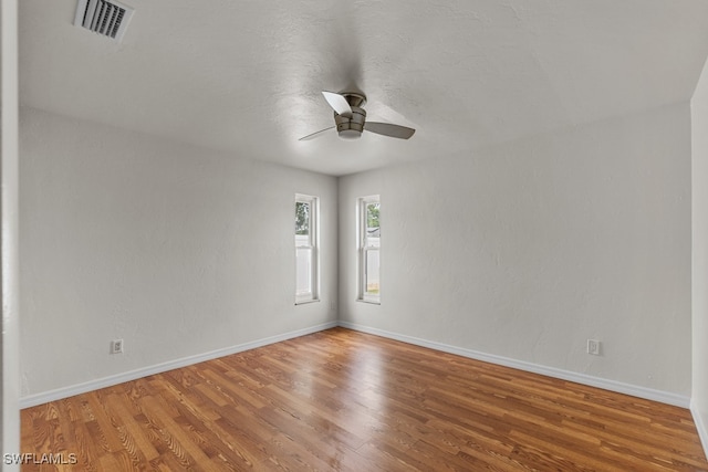 empty room featuring hardwood / wood-style floors and ceiling fan