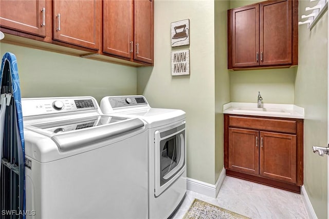 washroom featuring cabinets, separate washer and dryer, sink, and light tile patterned floors