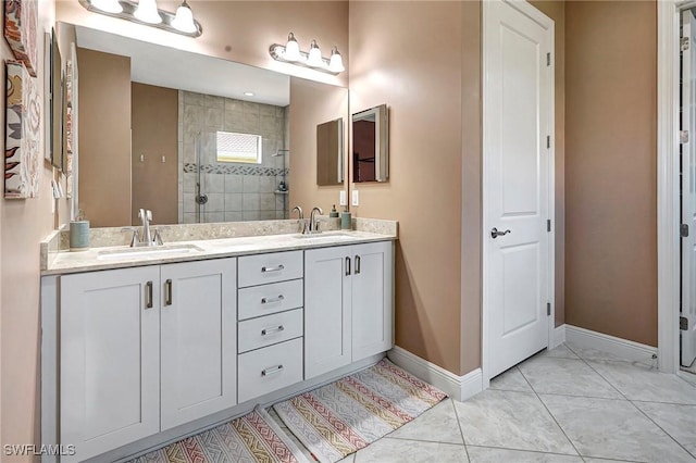 bathroom featuring tile patterned floors, vanity, and tiled shower