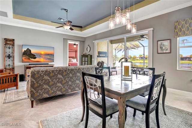 dining area featuring a raised ceiling, ceiling fan, plenty of natural light, and light tile patterned floors